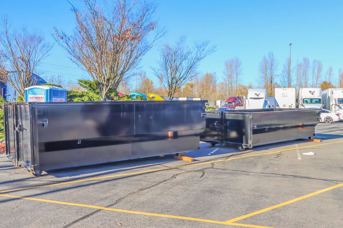 Professional dumpster rental service with roll-off container on residential driveway in New Bedford